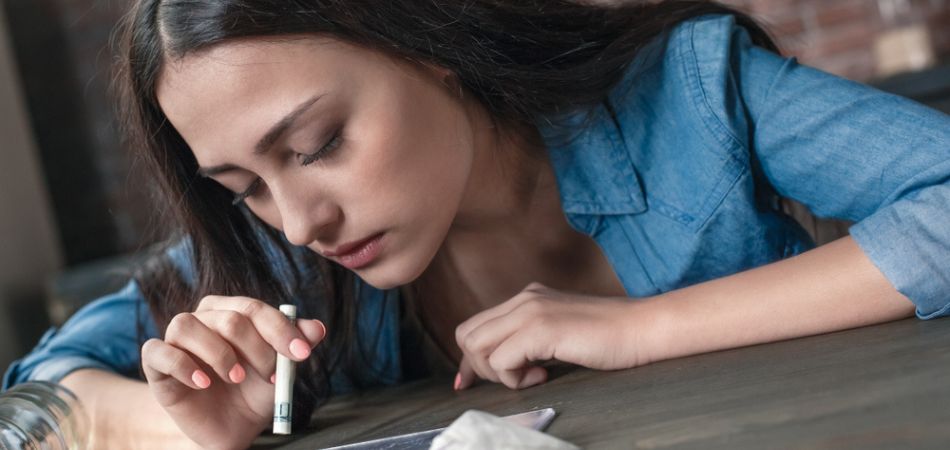 young woman inhealing cocaine